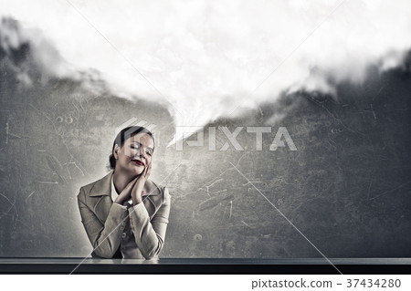 Attractive businesswoman sitting at table Attractive businesswoman sitting at table 37434280