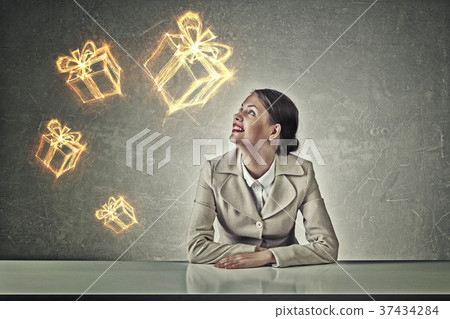Attractive businesswoman sitting at table Attractive businesswoman sitting at table 37434284