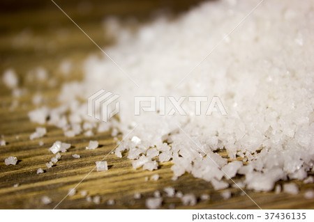 Large sea salt on wooden background Large sea salt on wooden background 37436135
