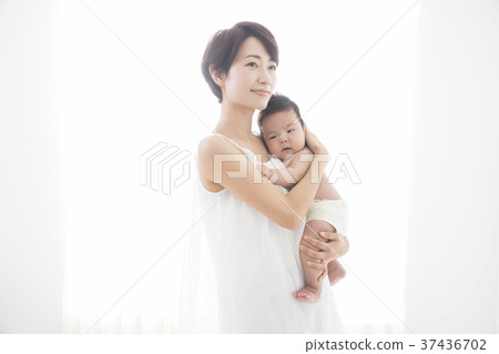 A woman who gently holds a baby A woman who gently holds a baby 37436702