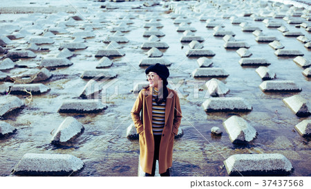 Woman standing near the river 37437568