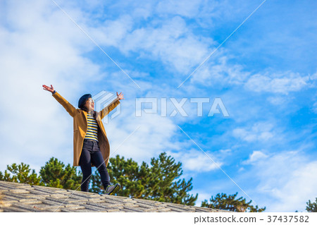 Woman walking alone on the bank Woman walking alone on the bank 37437582