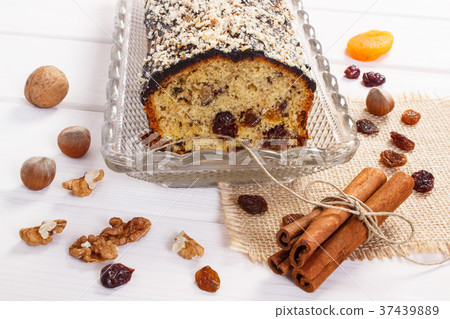 Fresh baked fruitcake with ingredients on boards 37439889