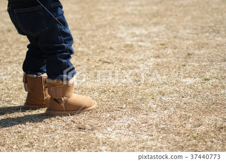 Feet of a boy playing in the park 37440773