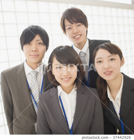 Businesswoman smiling at office and businessman 37442926