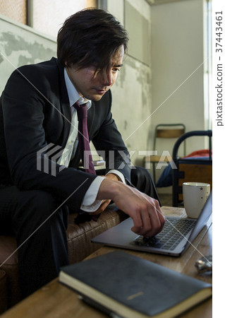 A man working on a computer A man working on a computer 37443461