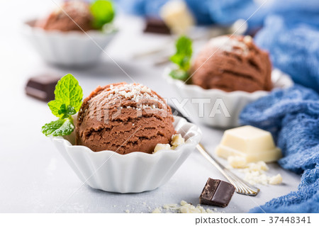 Chocolate ice cream in white bowl. 37448341