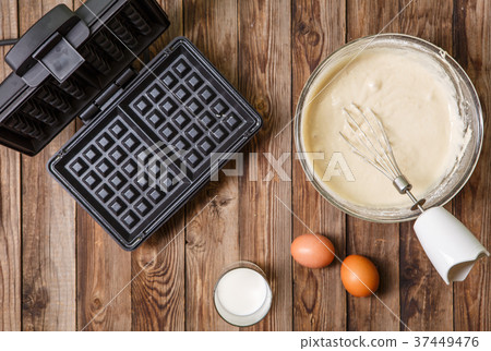 Making waffles at home - waffle iron, batter in Making waffles at home - waffle iron, batter in 37449476