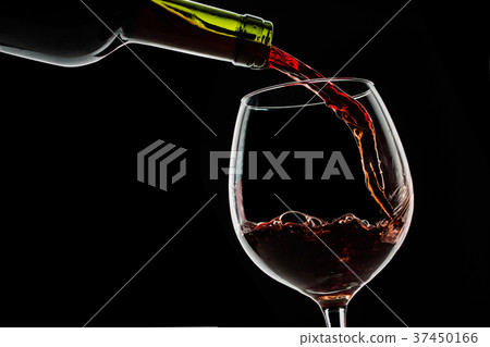 Grape wine poured into wine glass on black 37450166