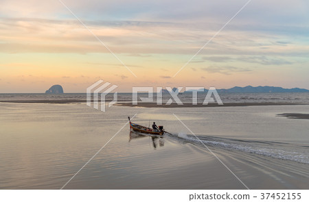 Fisherman is riding the long tail boat. 37452155