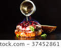 Burning burger is poured with spirits. 37452861