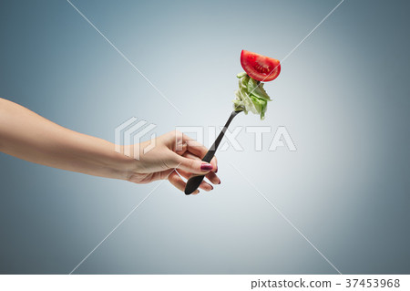 Beautiful woman hand holding a red rose Beautiful woman hand holding a red rose 37453968