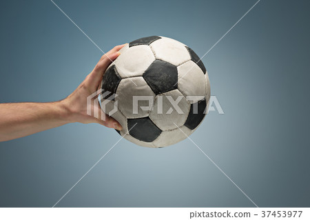 Hands holding soccer ball 37453977