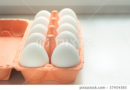 Organic white eggs in egg box. Close up. Organic white eggs in egg box. Close up. 37454365