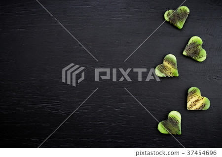 Hearts made of kiwi fruit on black background Hearts made of kiwi fruit on black background 37454696