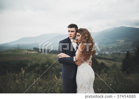 Young newly wed couple, bride and groom kissing Young newly wed couple, bride and groom kissing 37454880