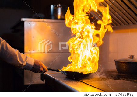 Flambe lamb rib roast. Cooking with fire in frying Flambe lamb rib roast. Cooking with fire in frying 37455982