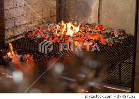 Typical Argentinian barbecue or asado. Burning Typical Argentinian barbecue or asado. Burning 37457152
