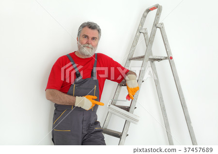 Worker painting room to white Worker painting room to white 37457689