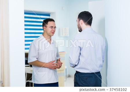 Doctor talking to a patient in a hallway 37458102