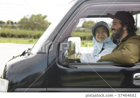 Foreigner and farmer woman driving a truck 37464681