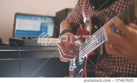 Young musician composes and records music playing 37467605