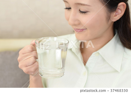 A woman drinking water A woman drinking water 37468330