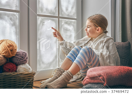 girl sitting by the window 37469472