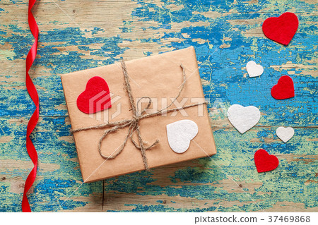 Gift box with hearts on blue vintage background Gift box with hearts on blue vintage background 37469868