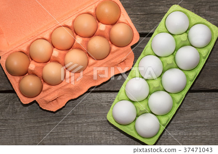 Carton of organic white and brown eggs on board. Carton of organic white and brown eggs on board. 37471043