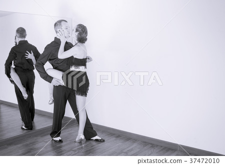 Couple of dancers dancing latin dances Couple of dancers dancing latin dances 37472010