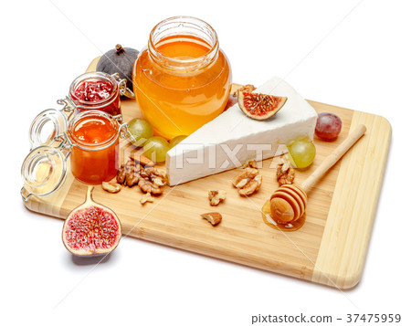 brie or camambert cheese and honey on a white 37475959