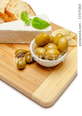 brie or camambert cheese and olives on a white brie or camambert cheese and olives on a white 37475964