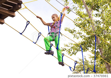 Girl climbing stairs at altitude in the amusement 37478981