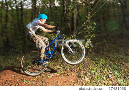 a young guy in a helmet flies landed on a bicycle a young guy in a helmet flies landed on a bicycle 37481968