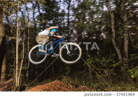 a young guy in a helmet flies on a bicycle after 37481969