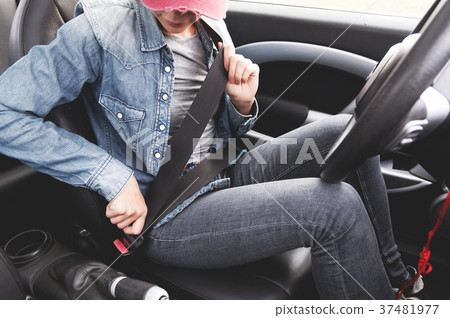A hipster girl wearing jeans clothes fastens her 37481977