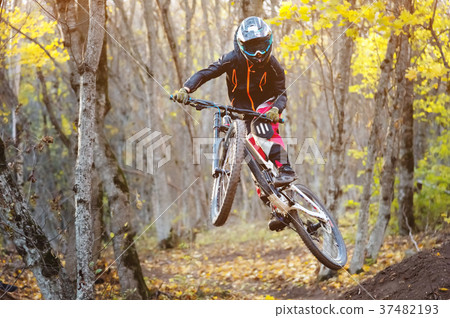 a young rider at the wheel of his mountain bike 37482193