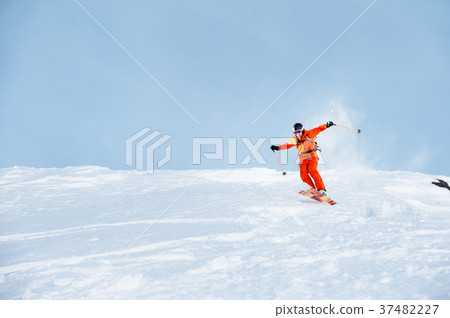 Ski athlete in a fresh snow powder rushes down the 37482227