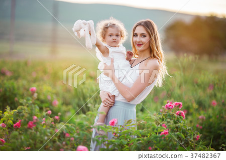 Blonde child girl with pretty young mother are 37482367