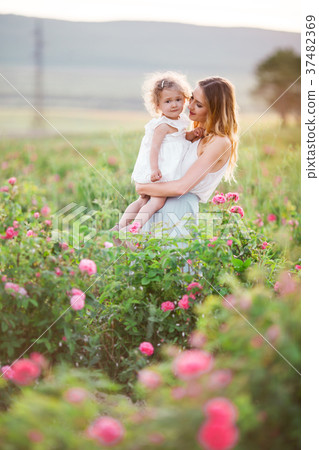 Beautiful child girl with pretty young mother are 37482369