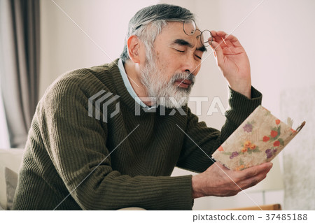 Senior men reading books with eyeglasses up 37485188