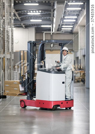 Male worker operating a forklift Male worker operating a forklift 37485916