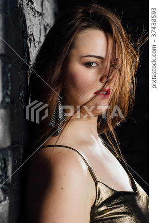 close-up portrait plus size model in a gold blouse close-up portrait plus size model in a gold blouse 37488593