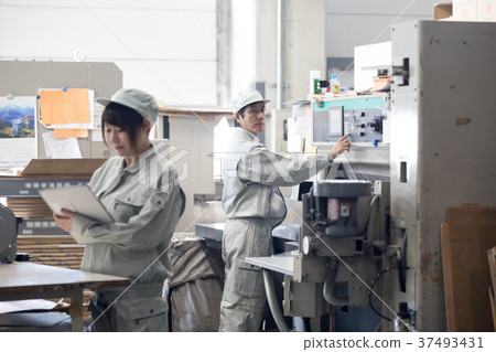 Male worker operating a town factory/machine 37493431