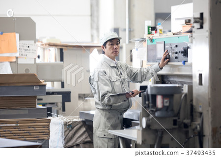 Male worker operating a town factory/machine Male worker operating a town factory/machine 37493435