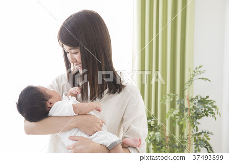 Woman holding a baby Woman holding a baby 37493899