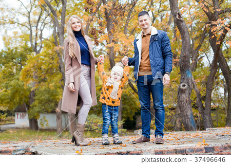 a family with a young boy in the autumn forest 37496646
