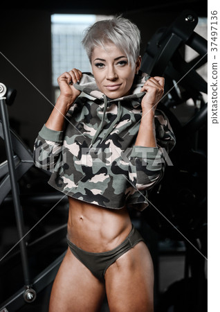 blonde sexy athletic young girl working out in gym.. 37497136