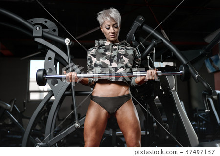 blonde sexy athletic young girl working out in gym.. blonde sexy athletic young girl working out in gym.. 37497137